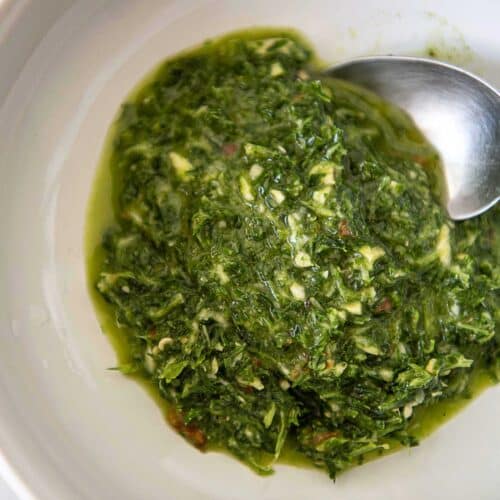 Photo of a bowl of bright green chimichurri