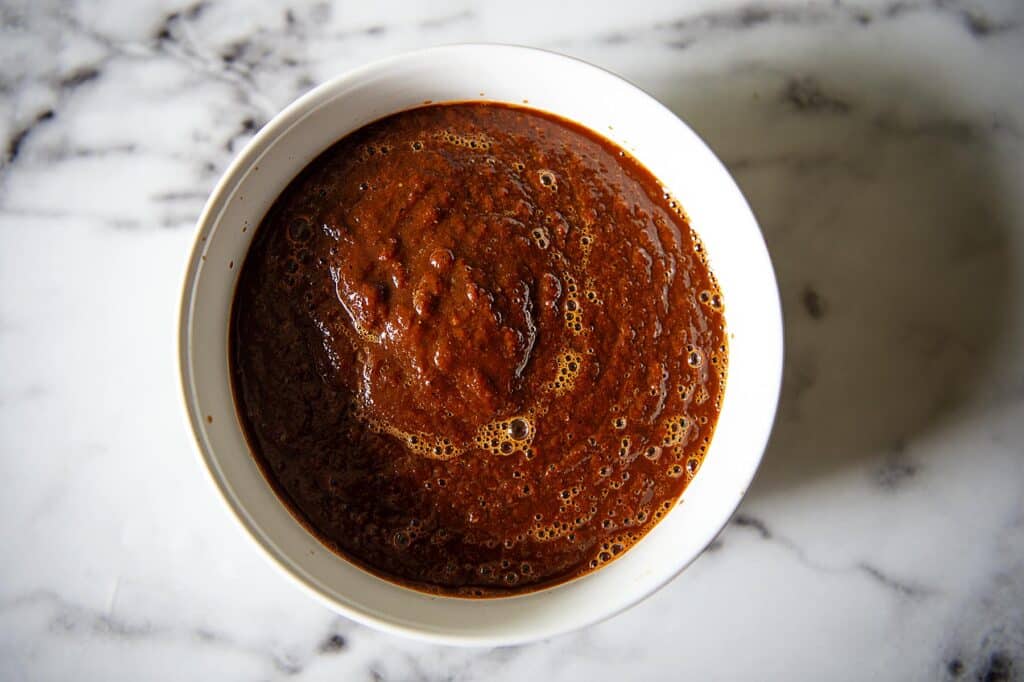 red enchilada sauce in a white bowl