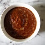 red enchilada sauce in a white bowl