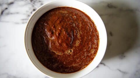 red enchilada sauce in a white bowl