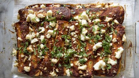 a tray of red chicken enchiladas