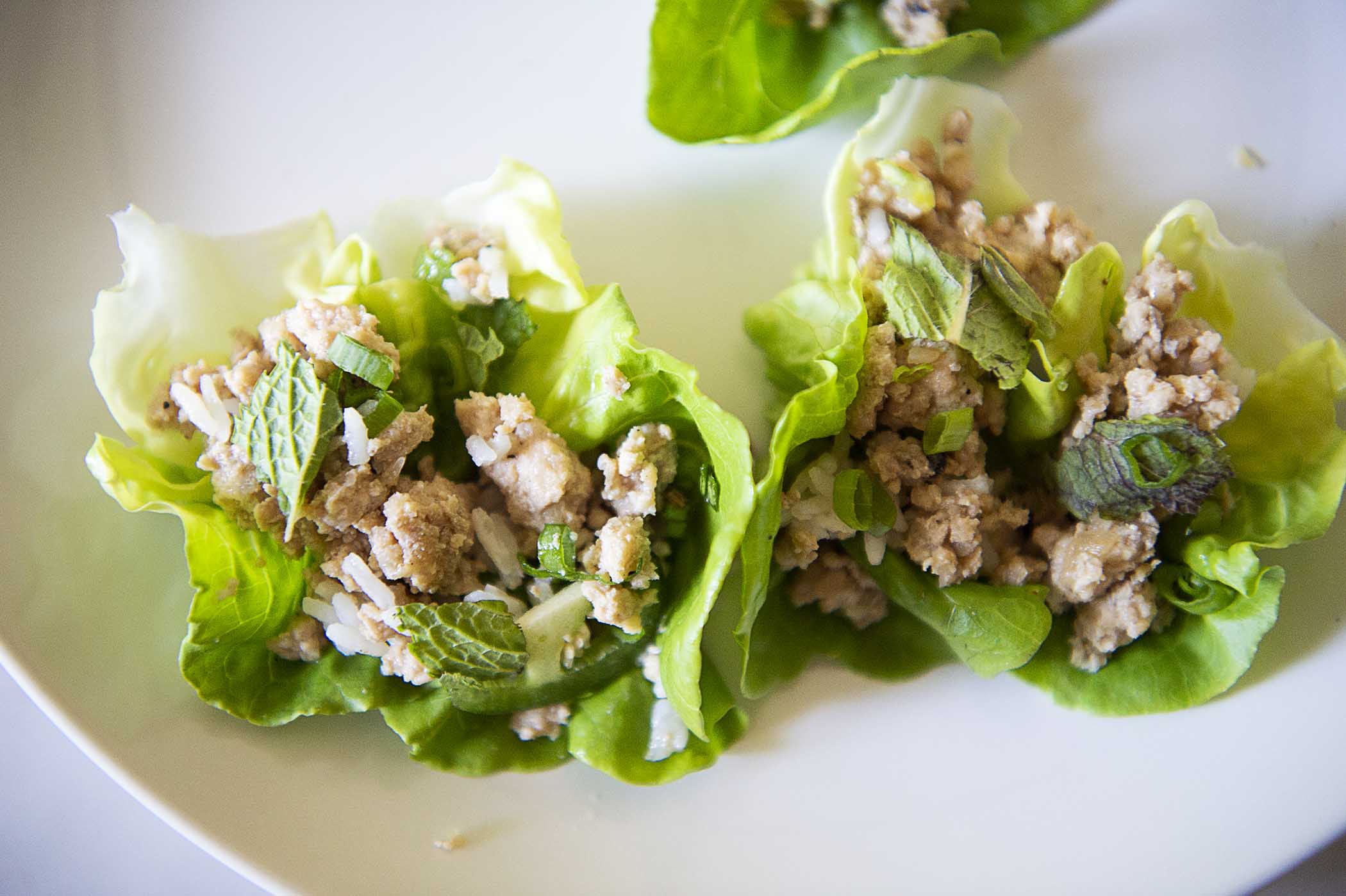 Chicken larb served in a lettuce cup with rice