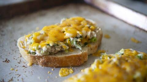 An open Tuna melt sandwich on a baking sheet