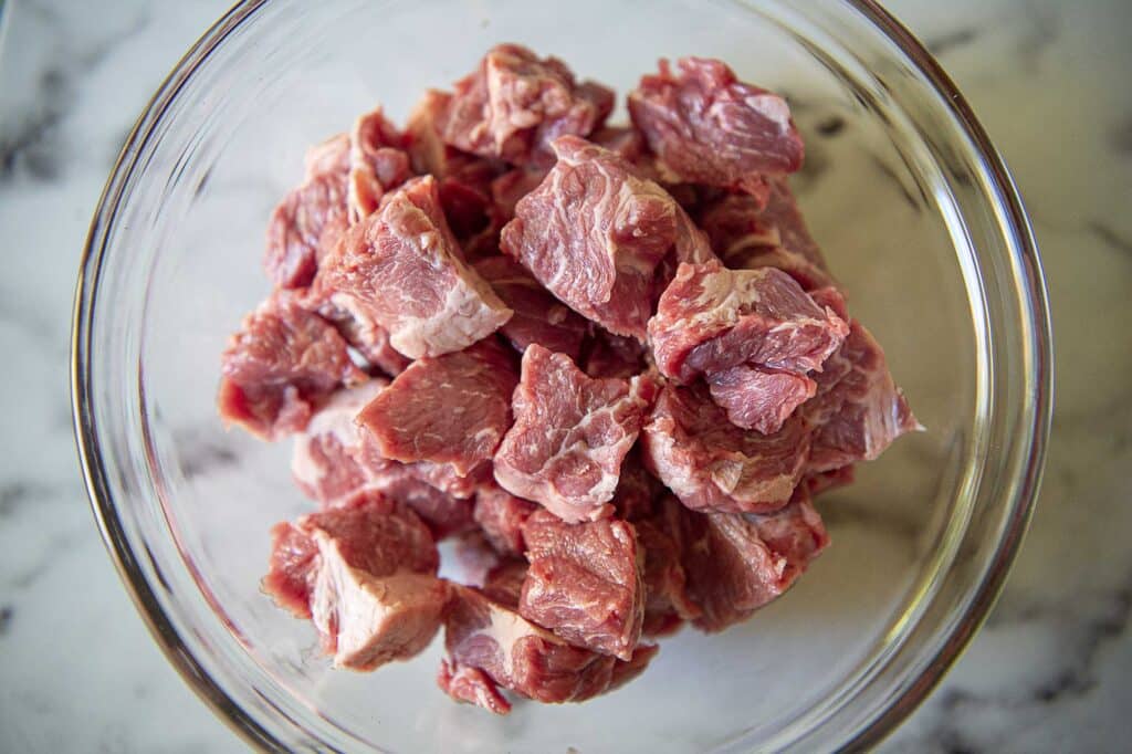 Chuck roast cut into 1 inch pieces in a bowl