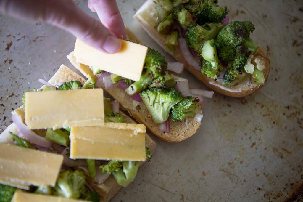 Cheese is placed on top of broccoli