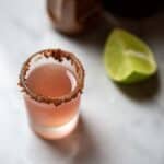 a Mexican candy shot next to a lime wedge