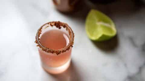 a Mexican candy shot next to a lime wedge