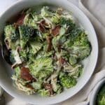 Chicken Salad Chick Broccoli Salad Recipe in a white bowl with a beautiful backdrop.