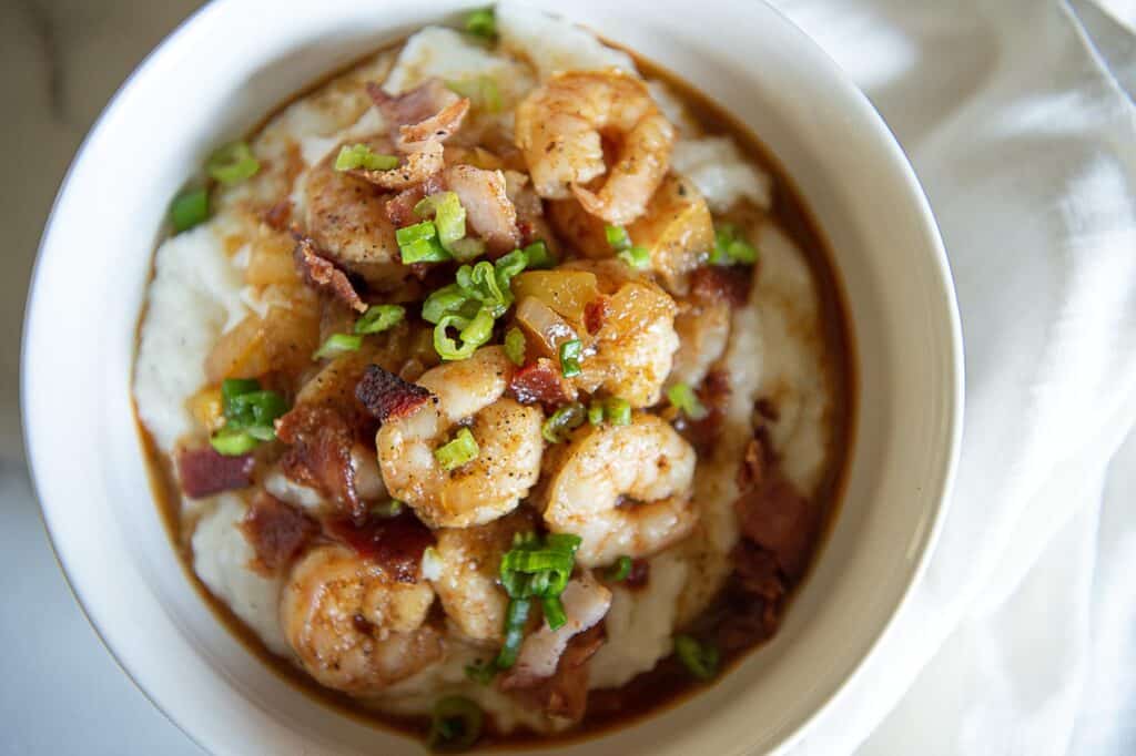 Shrimp and grits in a white bowl