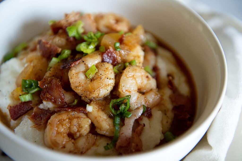 Shrimp and grits in a white bowl