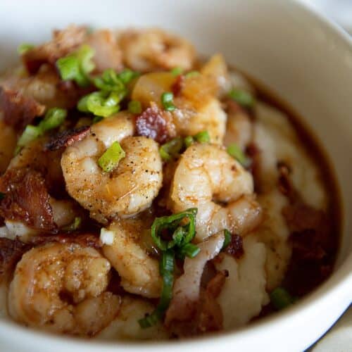 Shrimp and grits in a white bowl