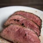 Trip Tip Steak Cut and Served on a white plate.