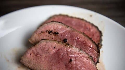 Trip Tip Steak Cut and Served on a white plate.