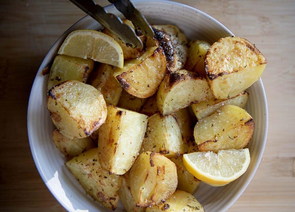 potatoes with lemon in a white bowl