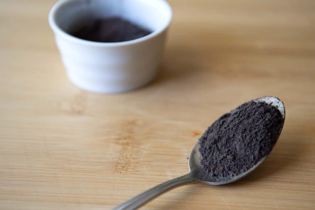 Alkanet in a spoon with a ramakin in the background.