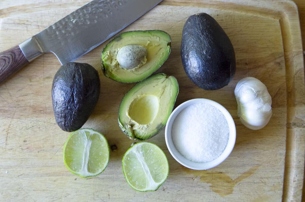 A shot of all of the ingredients for a 4 ingredient guacamole.