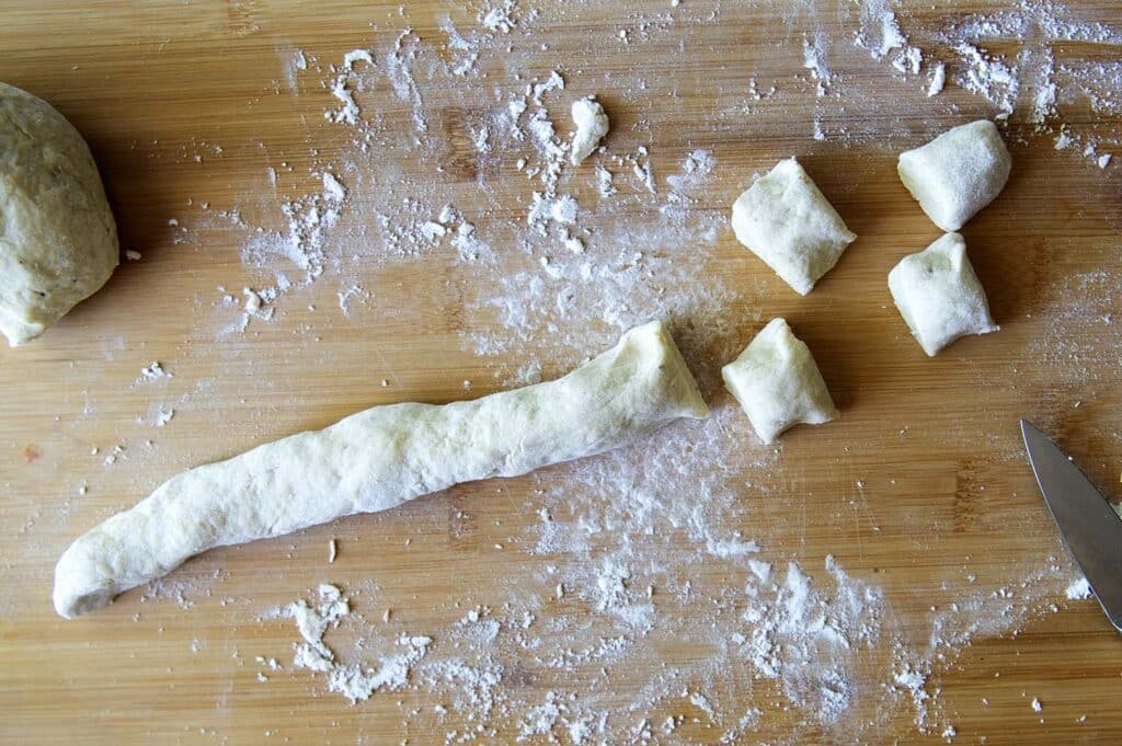 A picture of the process of cutting the dumplings to size for Knoephla soup.