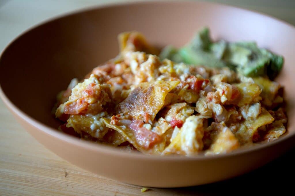 A beautiful plate of Migas in a gorgeous ceramic bowl.