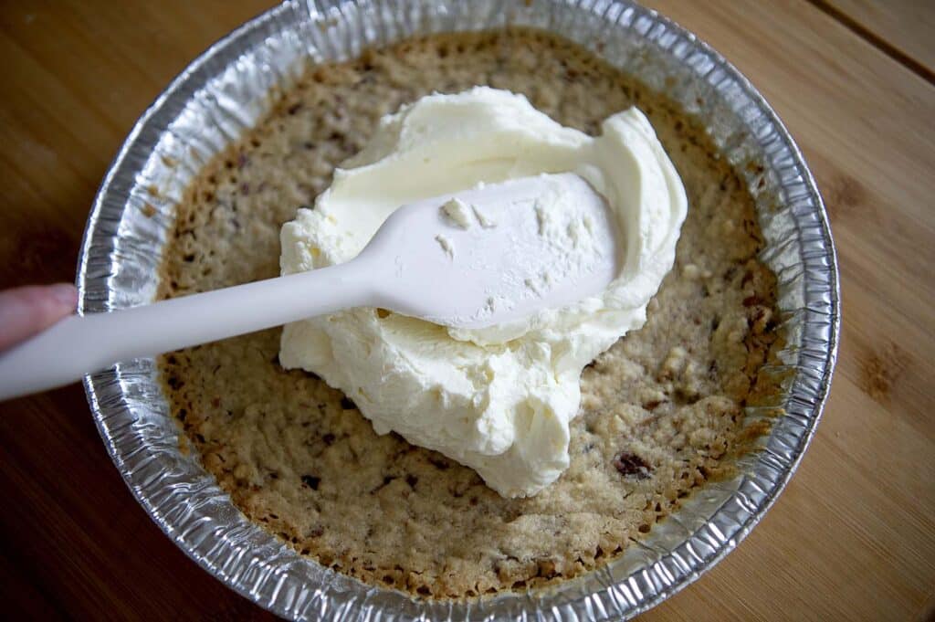 Spreading a cream cheese layer to build a possum pie