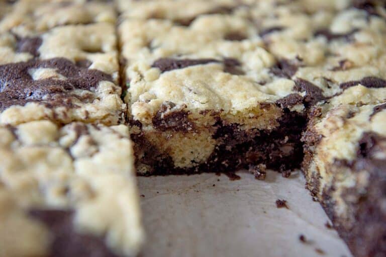 Close-up of sliced homemade marble brownies, featuring a mix of chocolate and vanilla swirled batter and a soft, crumbly texture—perfect for anyone seeking a delicious brookie recipe.