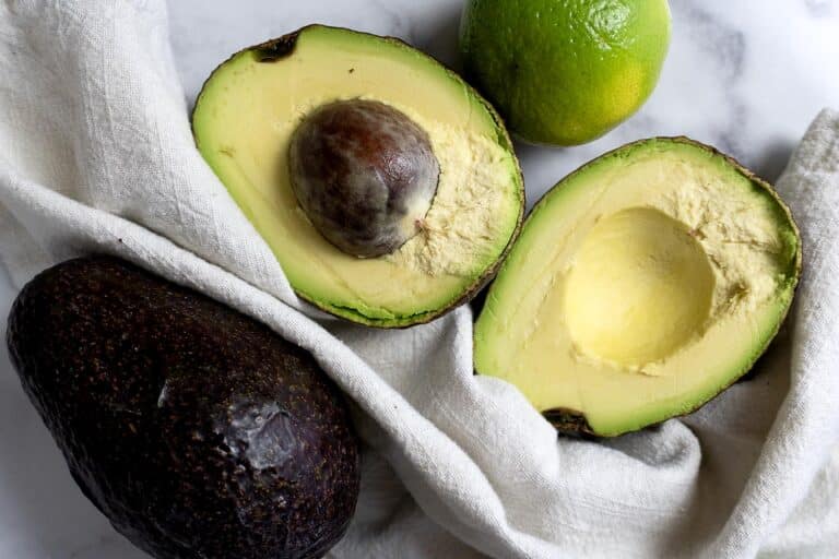 A avocado cut in half and a lime.